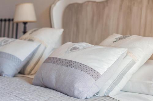 a bed with white pillows on it with at Orchidea Del Garda in Peschiera del Garda