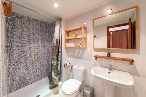 a bathroom with a toilet and a sink and a shower at Apartment Nerea in L'Escala