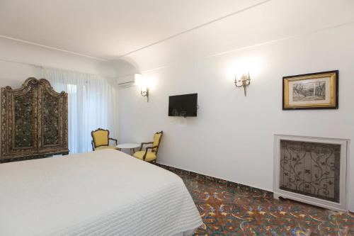 a hotel room with a bed and a fireplace at Villa Silia in Capri