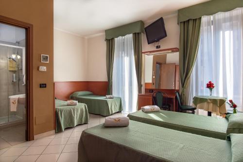 Posteľ alebo postele v izbe v ubytovaní Hotel Dorè
