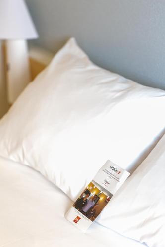 a bed with a hotel sign sticking out of it at Ibis Elche in Elche