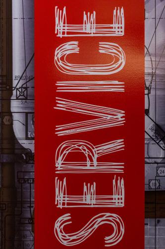 a red sign with white drawings on it at Ibis Elche in Elche
