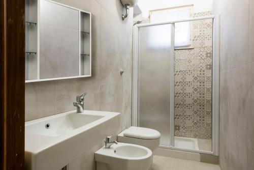 a bathroom with a sink and a toilet and a shower at casa blu in Follonica