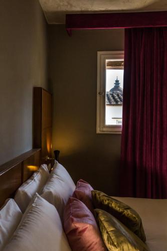 Un ou plusieurs lits dans un hébergement de l'établissement Oltrarno Splendid