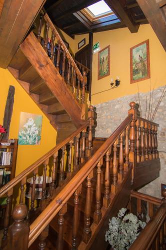 a wooden staircase in a home with yellow walls at La Casona de Tresgrandas in Tresgrandas