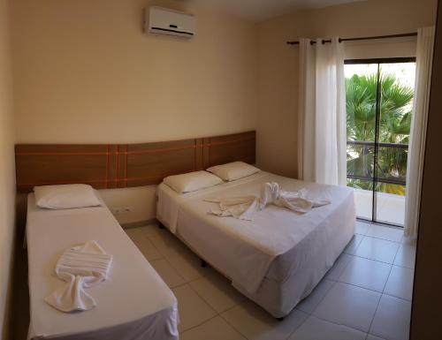 Säng eller sängar i ett rum på Aquaville Apart Hotel