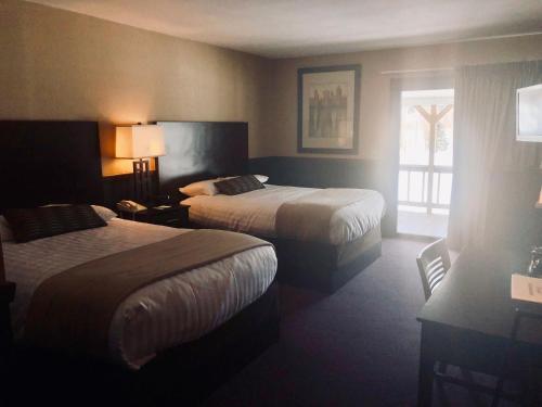 a hotel room with two beds and a window at Byrncliff Golf Resort in Varysburg