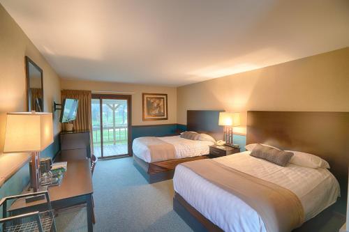 a hotel room with two beds and a television at Byrncliff Golf Resort in Varysburg