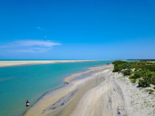 an aerial view of a beach with a boat in the water at Refugios Parajuru - Casa Manga in Parajuru