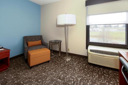 a room with a chair and a lamp and a window at Best Western Plus Bellingham in Bellingham