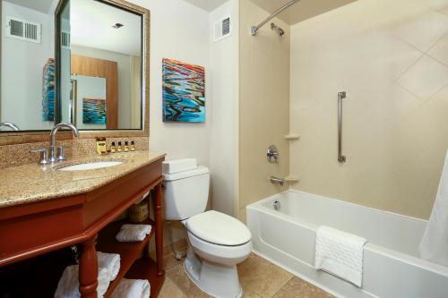 a bathroom with a toilet and a sink and a tub at Best Western Plus Bellingham in Bellingham