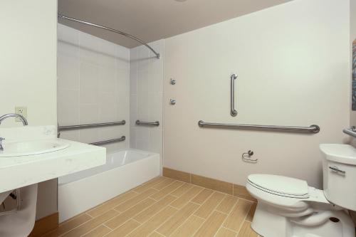 a white bathroom with a toilet and a sink at Best Western Plus Bellingham in Bellingham