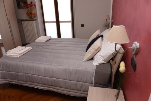 a bedroom with a bed with a lamp next to it at Casa Dante in Romano di Lombardia