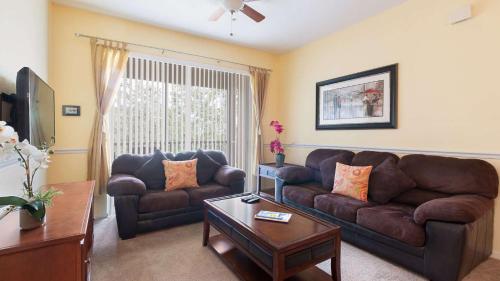 a living room with a couch and a table at Disney at your doorstep in Orlando