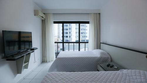 Llit o llits en una habitació de Bristol Metropolitan Curitiba Centro