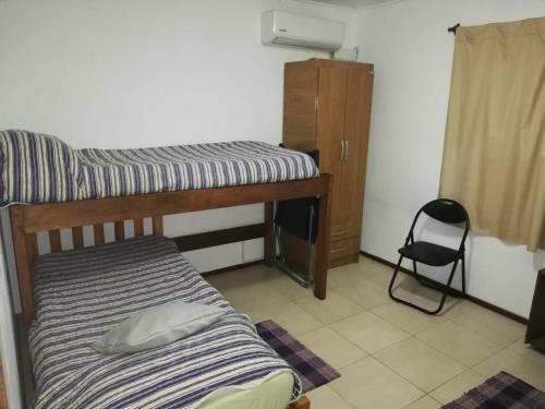 a bedroom with a bunk bed and a desk at la casita de colonia 2 in Colonia del Sacramento
