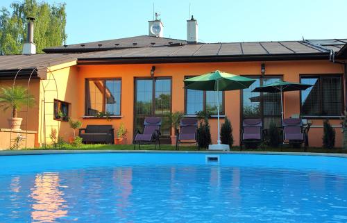 a house with a swimming pool in front of it at Meissa in Mostek