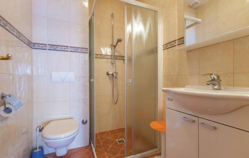 a bathroom with a shower and a toilet and a sink at Apartments Villa Amalia in Omiš