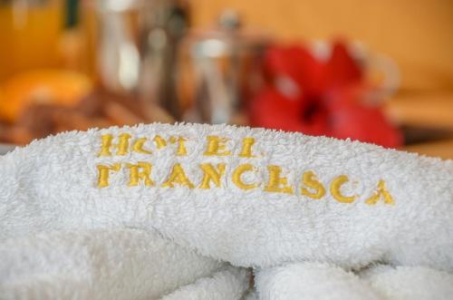 a white towel with the words haega francisco on it at Hotel Francesca in Agios Prokopios