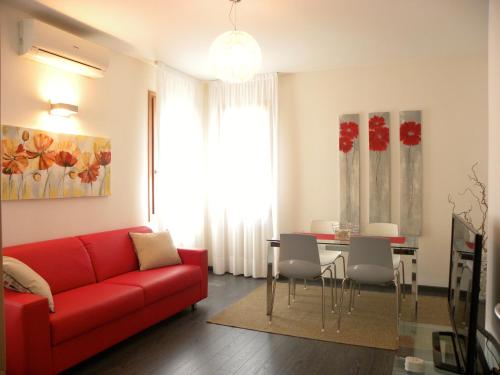 a living room with a red couch and a table at Venice Apartments Dante in Mestre