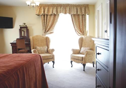 Ένα ή περισσότερα κρεβάτια σε δωμάτιο στο Cotford Hotel