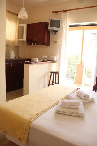 a bedroom with a bed with towels on it at Villa Martha in Benitses