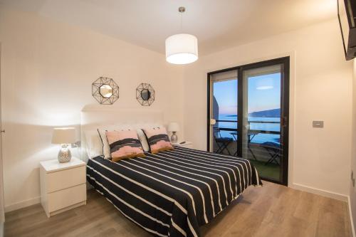 a bedroom with a bed with a view of the ocean at Tabaiba Premier Views Apartment in Tabaiba