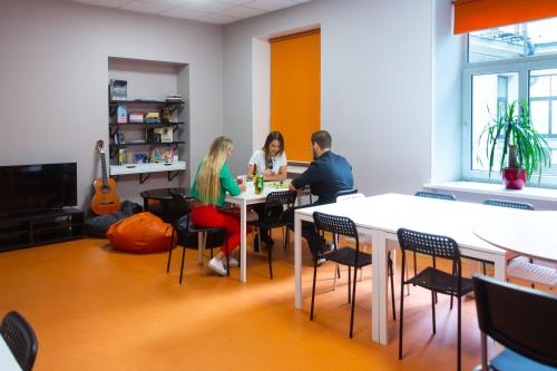 a group of people sitting at a table in an office at Liberty Airy in Rīga