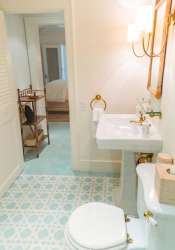 a bathroom with a sink and a toilet at Eleven Bahama House in Harbour Island