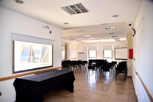 a room with a table and chairs in it at Hotel Confianza in Corrientes