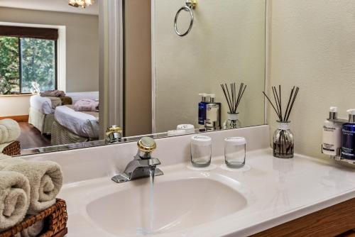 a bathroom with a sink and a mirror at Sheridan House Inn- Adult Only Accommodation in Williams