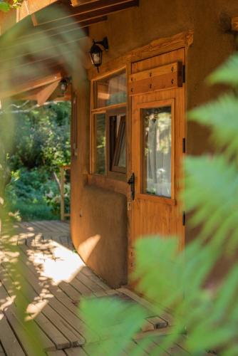 a wooden door of a house with a window at Complejo Cabañas Quilamalen in Villarrica
