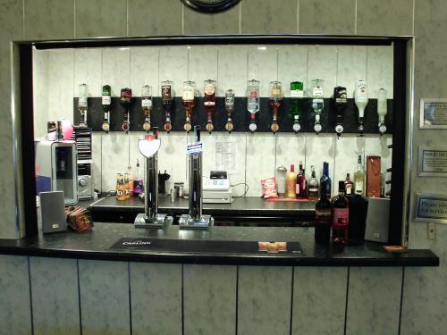 a counter in a room with a bar with bottles at Brincliffe Hotel in Blackpool