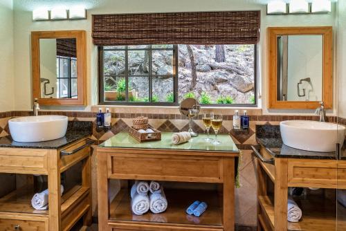 a bathroom with two sinks and two mirrors at Sheridan House Inn- Adult Only Accommodation in Williams