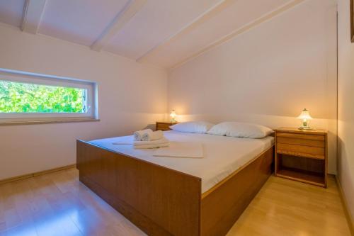 a bedroom with a bed with two towels on it at Two-Bedroom Apartment in Crikvenica XXXIII in Dramalj
