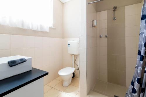 a bathroom with a toilet and a shower at The Prince Mark Motel in Eumemmerring