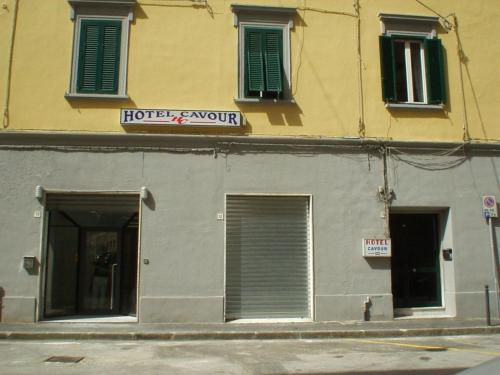 a building with two doors and a sign on it at Albergo Cavour SELF CHECK-IN in Livorno