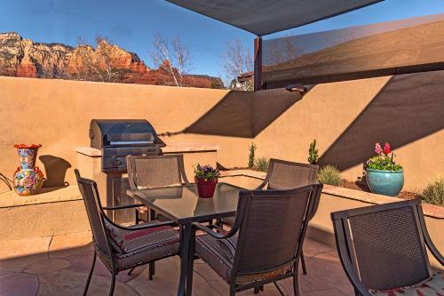 a patio with a table and chairs and a grill at Sedona Uptown Suites in Sedona