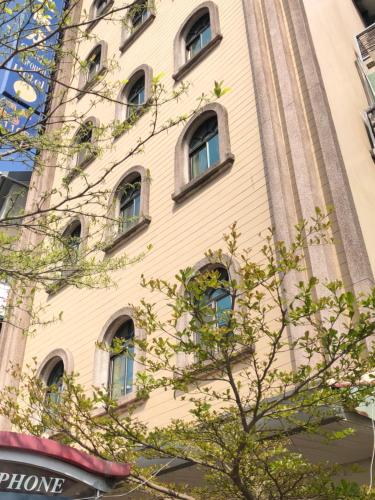 a tall building with windows on the side of it at Good Ground Hotel Tainan in Tainan