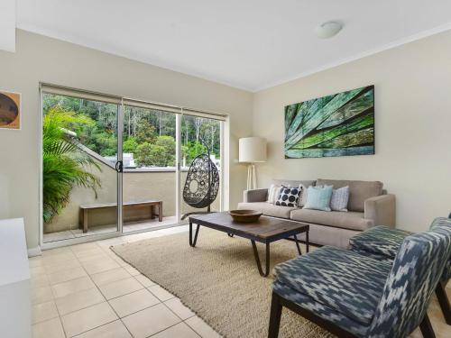 a living room with a couch and a table at Barrenjoey at Iluka Resort Apartments in Palm Beach