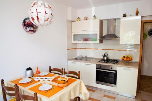 a kitchen with a table and a stove top oven at Apartment Vrbnik 8 in Vrbnik