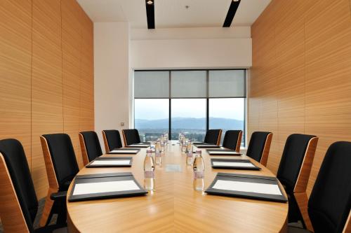 a conference room with a long table and chairs at Radisson Blu Plaza Hotel Ljubljana in Ljubljana