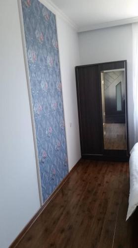 a room with a mirror and a dresser in a room at Guesthouse Elli & Cottages in Stepantsminda