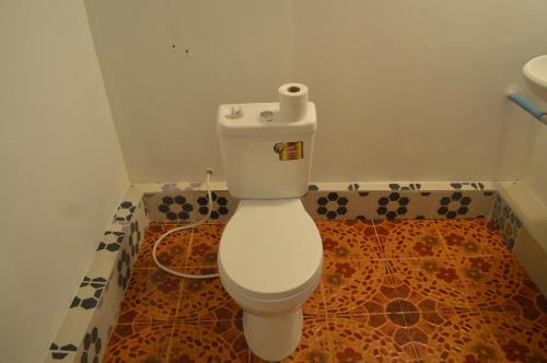 a bathroom with a toilet with a roll of toilet paper on it at Sok Phen Homestay in Siem Reap