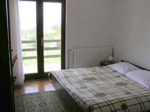 a bedroom with a bed and an open door at Apartment Pasman 1 in Pašman