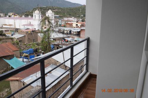 a balcony with a view of a city at Arum Qurpawasi Hospedaje in Cabanaconde