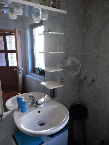 a white bathroom with a sink and a mirror at Müritzblick am Wünnow in Röbel