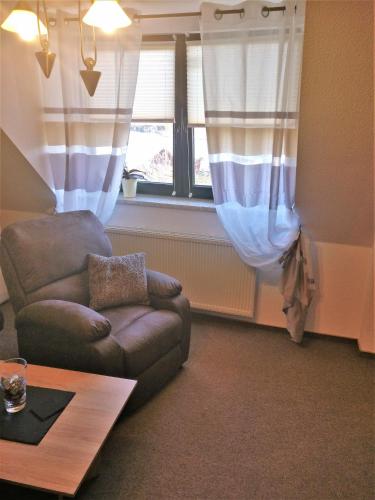 a living room with a couch and a window at Müritzblick am Wünnow in Röbel