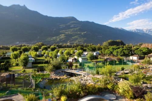a small town with a mountain in the background at Relais de la Sarvaz in Saillon