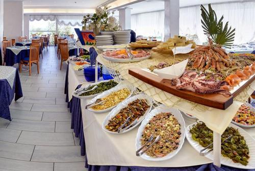 a buffet line with many different plates of food at Hotel Margareth in Riccione